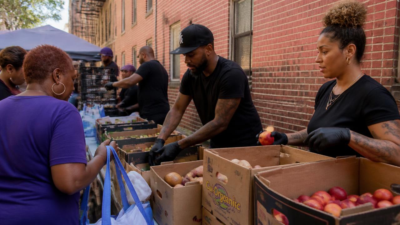 Volunteers distributing fresh produce at a community food pantry